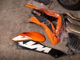 a motorcycle that is sitting on the ground next to other parts