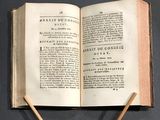a open book with two wooden sticks sticking out of it