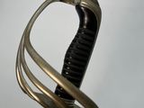 a close up of a sword with a curved handle