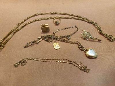 a lot of jewelry that is laying out on the table