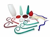 a group of different colored glass items on a white surface