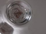 a close up of a glass of water with a stop sign in it