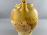 a yellow vase that is sitting on a table