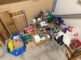 a pile of assorted items on the floor of a garage