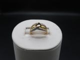a close up of a ring with a diamond on top of it