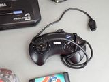 a video game controller and a cell phone on a table