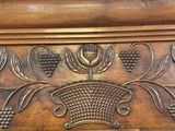 a close up of a carved wood door with grapes on it