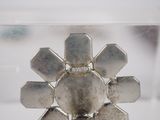 a silver object in a clear box on a table