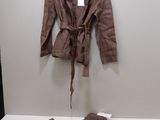 a jacket and pants on a hanger in a room
