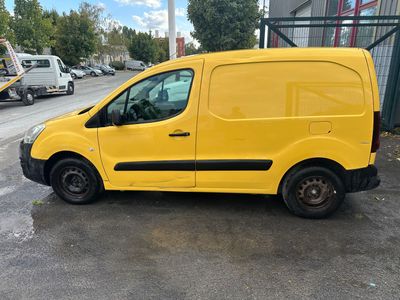 a yellow van parked in a parking lot next to a building