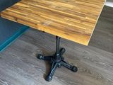 a small table with a wooden top on a wooden floor