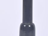 a black vase with a gold top sitting on a white surface