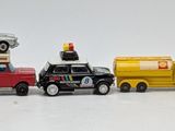 several toy cars are lined up in a row on a white surface