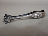 silver spoon with flowers on it sitting on a white surface