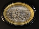 a picture of a black and gold plate with a pile of dried flowers in it