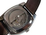 a close up of a watch with a brown leather strap