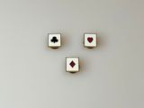 four playing cards are arranged in the shape of a face on a white surface