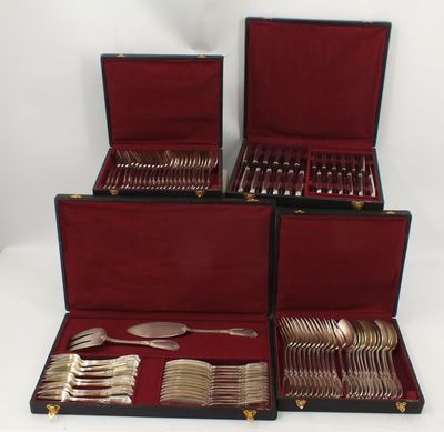 four pieces of silverware in a red case on a white surface