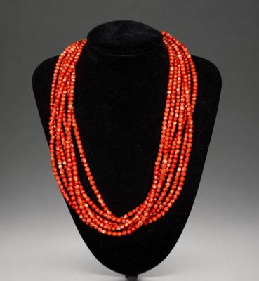 un collier de perles rouges sur un mannequin noir
