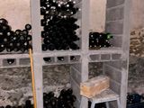 bottles of wine are stacked on shelves in a wine cellar