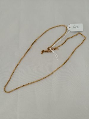 a gold chain necklace with a heart charm hanging from it ' s end