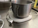 a mixer on the counter in the kitchen next to a bowl