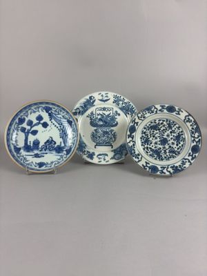 four blue and white plates with flowers and birds on them
