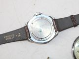 a watch that is sitting on a table next to a watch