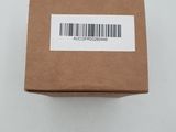 an open brown box with a barcode on it on a white surface