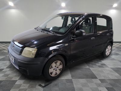 a picture of a small black van parked in a garage