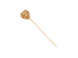 a close up of a gold stick with a heart on it
