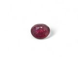 a close up view of a red ruby stone on a white background