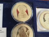 the four gold coins are in a display case on the table