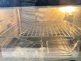 a glass oven door that is open with food in it