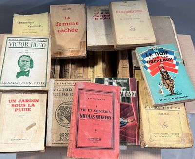 a lot of books that are stacked on top of each other