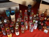 many bottles of alcohol sitting on a red table