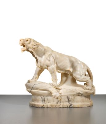 an ivory sculpture of a lion on a rock with its mouth open