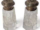 two salt and pepper shakers on a white surface
