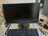 a computer monitor and keyboard sitting on a desk