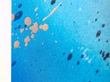 an open book with a picture of a blue sky and some black dots