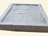 a cement block with a picture on it on a white background