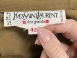 a person holding a piece of clothing that has a label on it