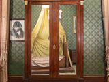 a large wooden cabinet with a mirror in it