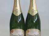 two bottles of champagne sitting next to each other on a table