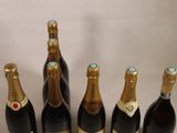 six bottles of champagne are lined up in a row on a table