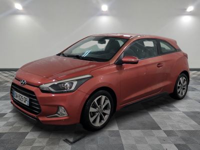 a red car parked in a garage with a checkered floor