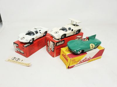 three toy cars are sitting on top of a box of boxes