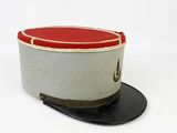 grey and red top hat with a black leather band on a white surface