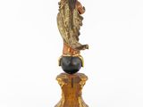 a statue of a woman holding a child on top of a globe
