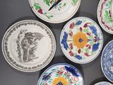 many plates with different designs on them on a table